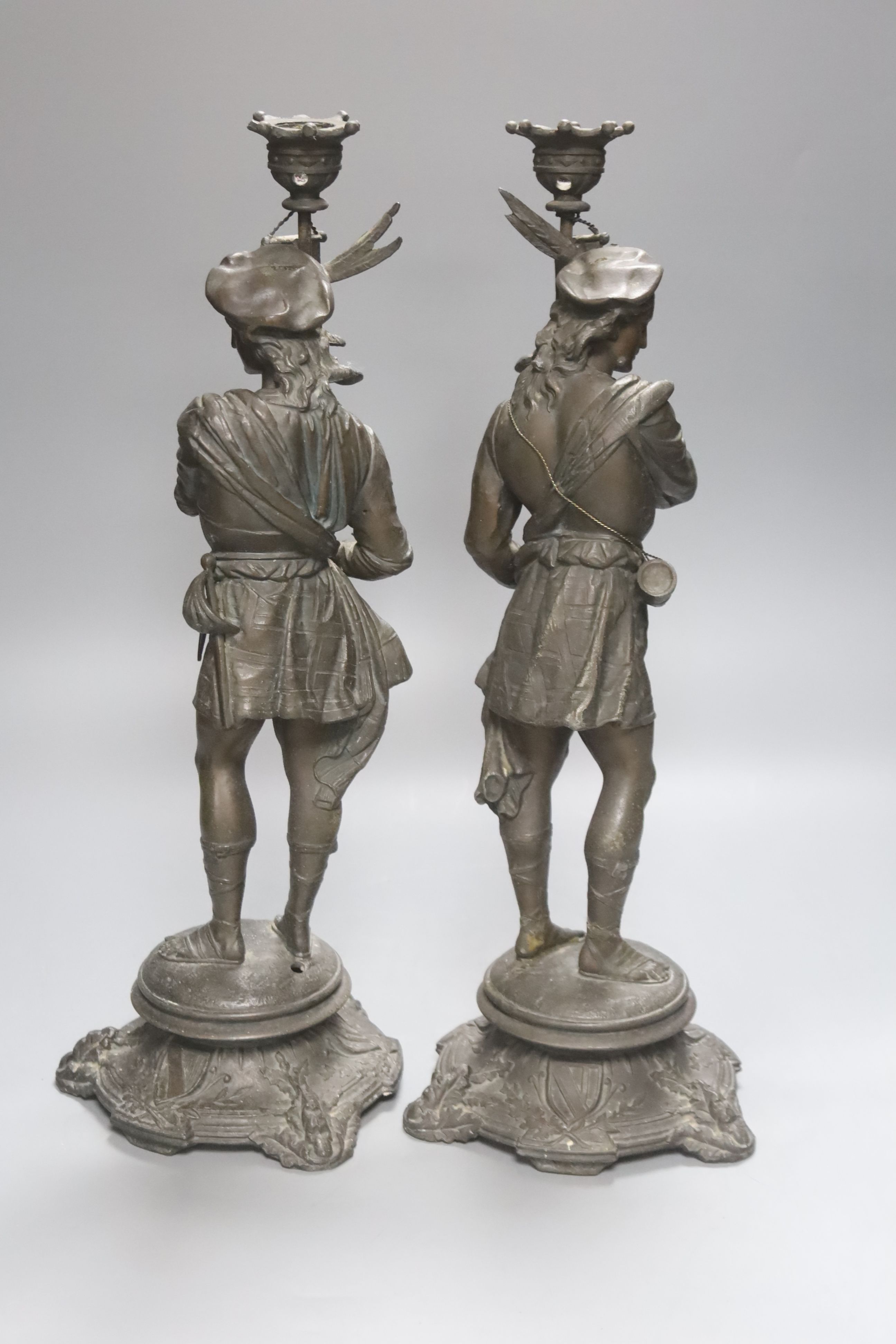 A pair of early 20th century spelter figural candlesticks, height 41cm